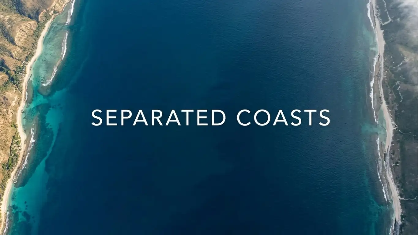 Two coastlines separated by open water under a clear sky, viewed from above